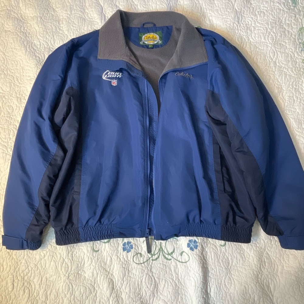 Cabela's Blue and gray jacket. Rain/wind proof outside, warm cotton inside.